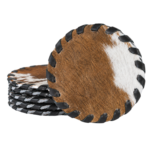 Set of four round genuine cowhide coasters with hand-laced dark leather edges on transparent background