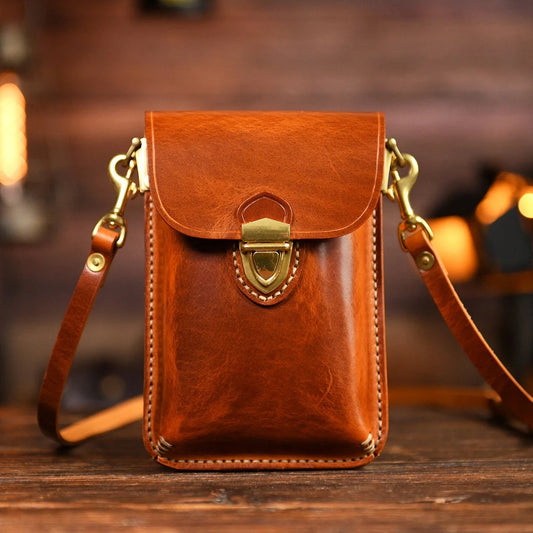 Vintage Brown top-grain leather crossbody phone bag on a warm wood surface