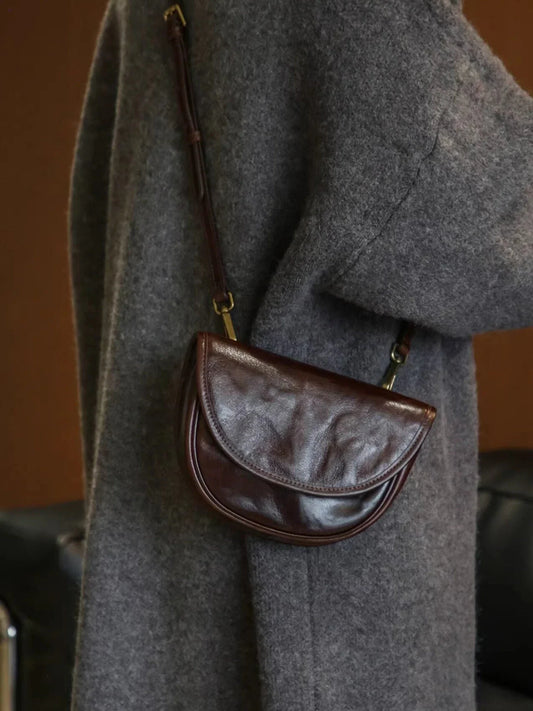 Ebony brown top-grain cowhide saddle bag worn crossbody