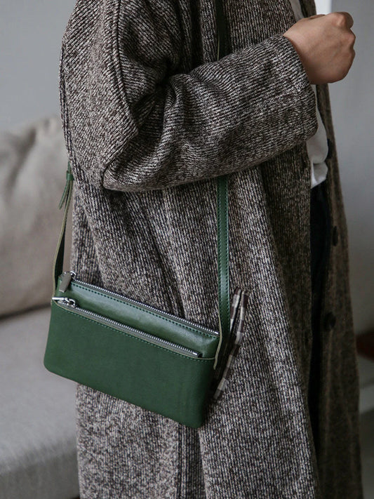 Forest green top-grain leather slim phone bag worn crossbody