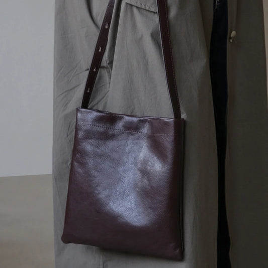 Front view of the ebony brown top-grain leather shoulder bag