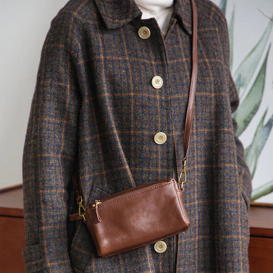Front view of the coffee brown top-grain leather crossbody bag