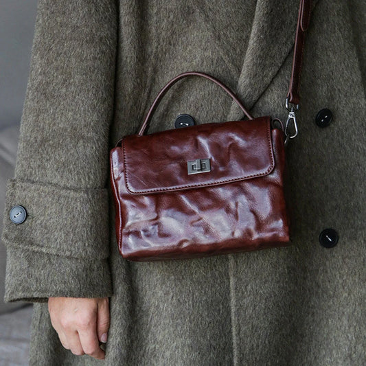 Chestnut brown leather satchel worn crossbody