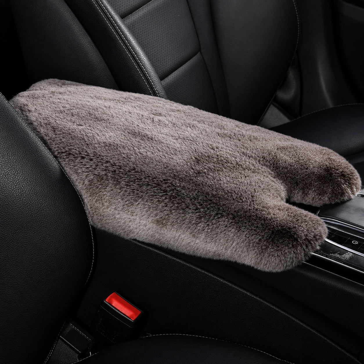 Brown frost genuine Rex rabbit fur center console armrest pad installed in a black car interior