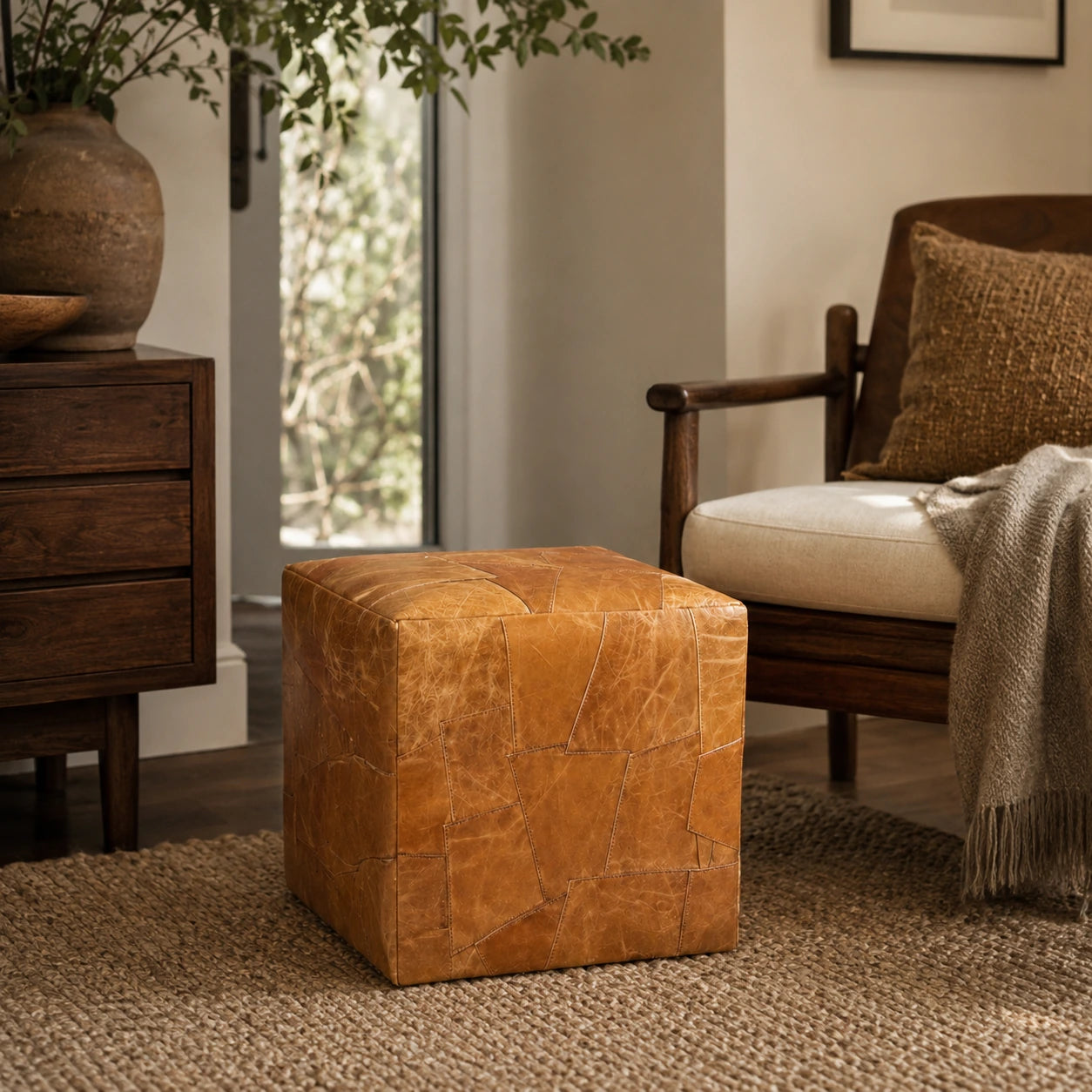 Honey brown leather cube ottoman styled in a warm wood living room