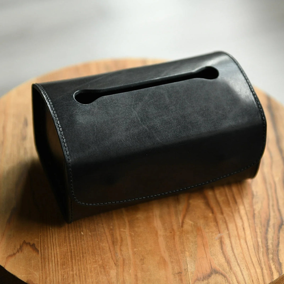 Black top-grain cowhide tissue box cover showing natural grain and stitching