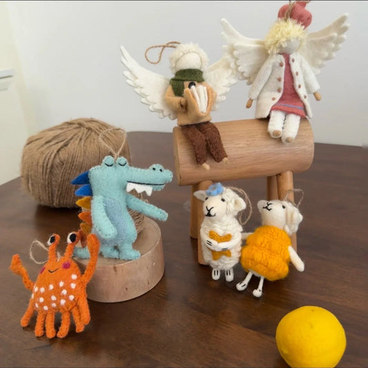 Handmade wool felt animal bag charms displayed as a colorful collection