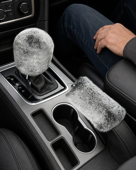 Silver gray Rex rabbit fur gear shift and handbrake covers in a parked SUV with an adult driver