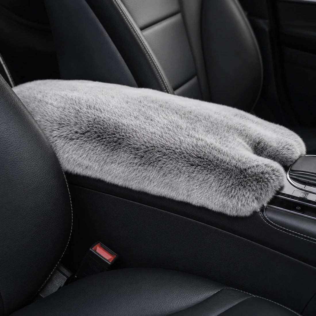 Silver gray genuine Rex rabbit fur center console armrest pad installed in a black car interior