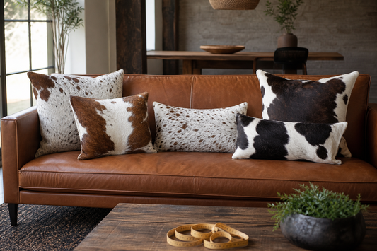 Cowhide square and lumbar pillow templates compared on a measured leather sofa