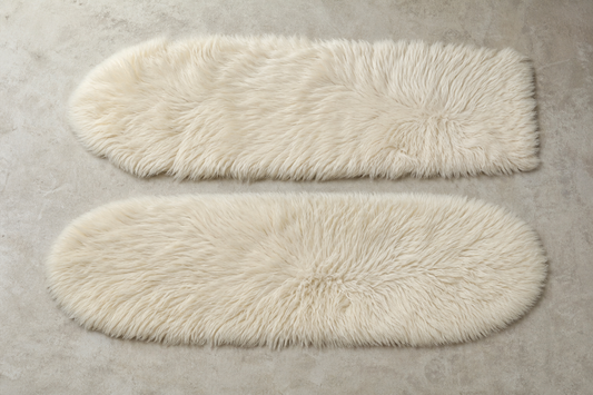 Two cream sheepskin runners showing one rounded end and two rounded ends