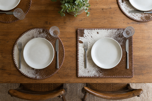 Round and rectangular cowhide placemat templates tested with the same plate, flatware, and glass