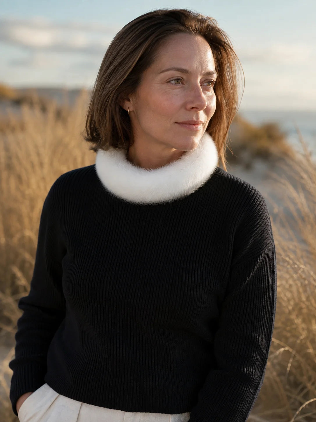 Woman wearing an ivory mink fur circular collar scarf outdoors