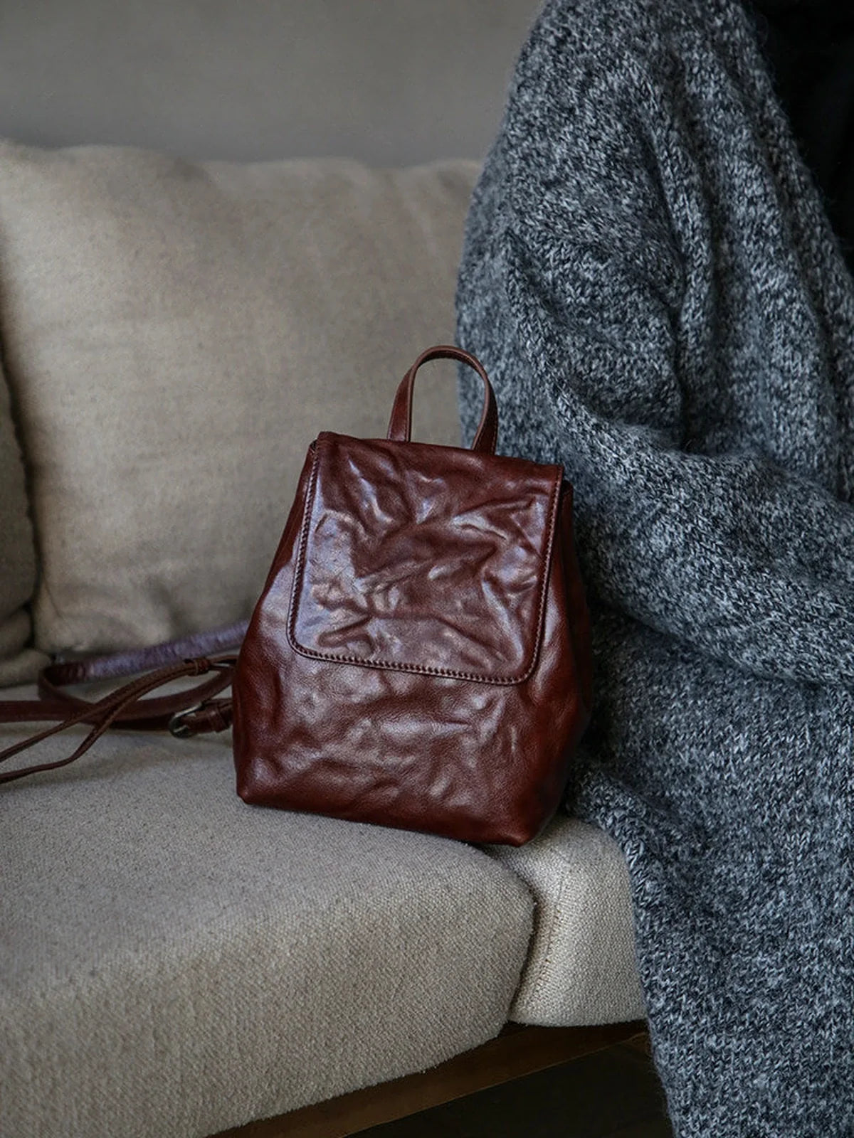 Coffee-brown vegetable-tanned cowhide mini backpack in a quiet interior
