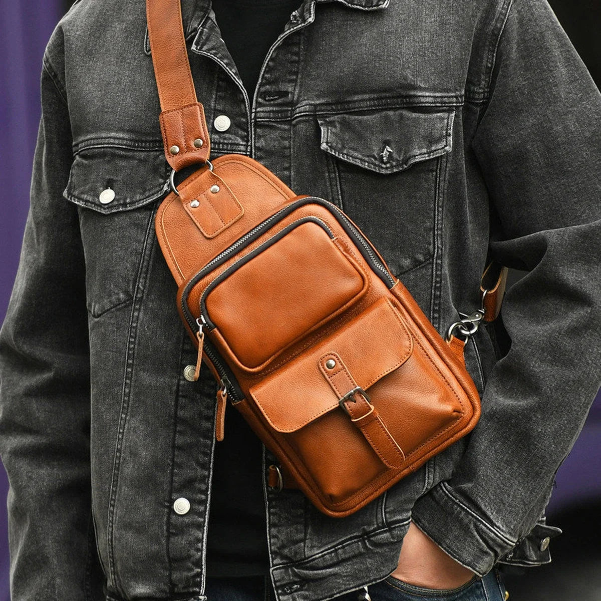 Men's brown vegetable-tanned leather sling bag worn crossbody