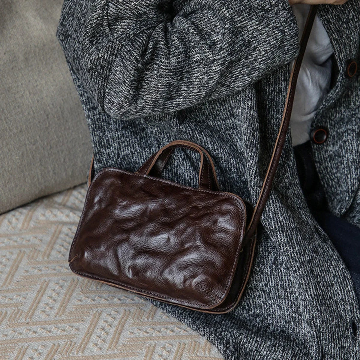 Coffee brown top-grain cowhide mini crossbody bag styled on the shoulder
