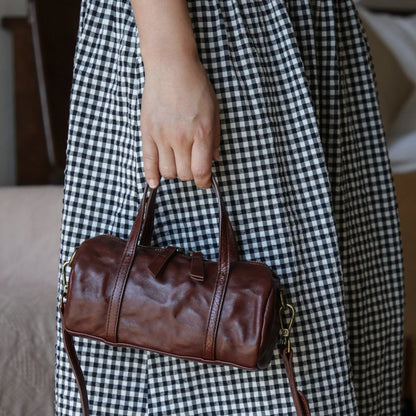Coffee Brown vegetable-tanned leather mini barrel bag carried by hand