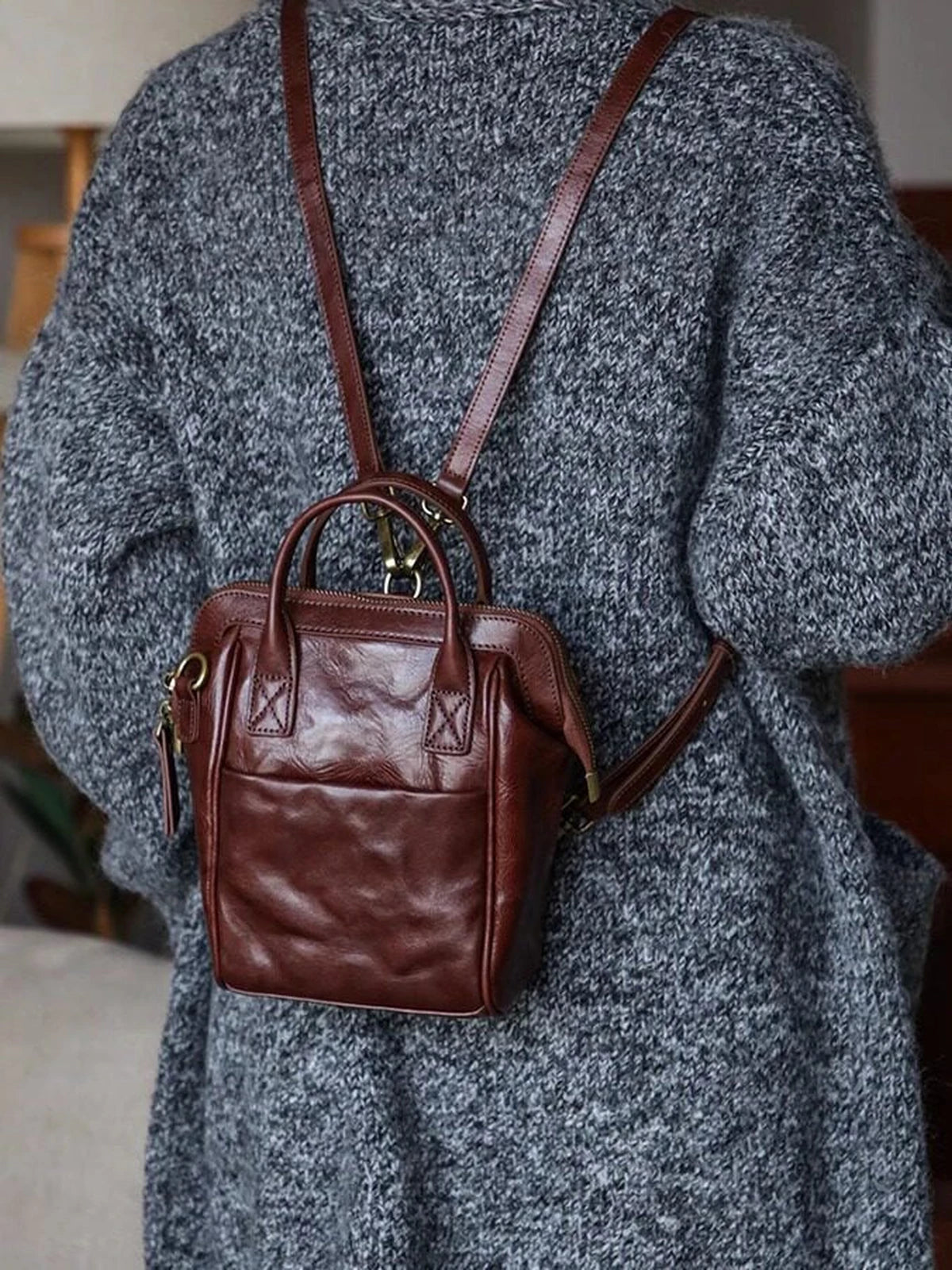 Coffee brown vegetable-tanned leather mini backpack worn on the back