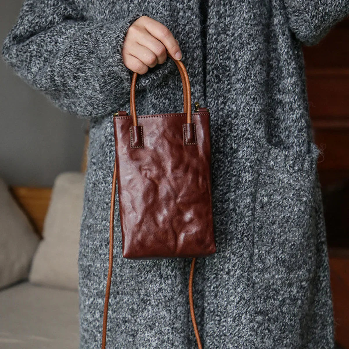 Coffee brown vegetable-tanned leather mini tote crossbody bag styled with a grey knit