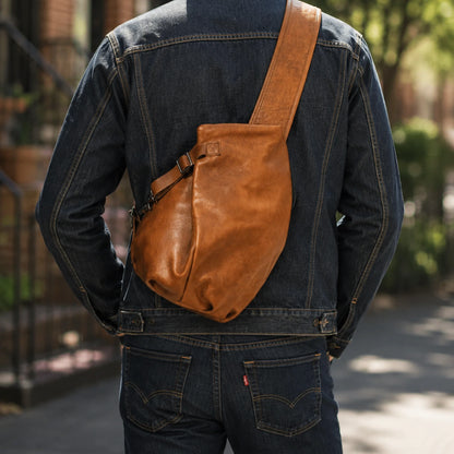 First-layer cowhide leather sling chest bag in Vintage Brown, worn crossbody