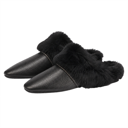 Black genuine cowhide and rabbit fur mule slippers pair on a transparent background
