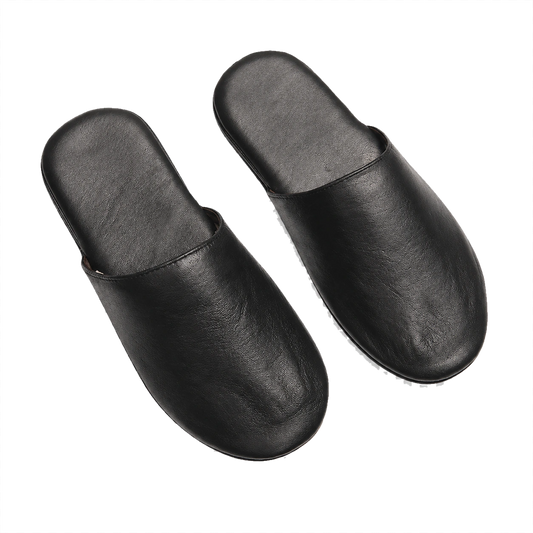 Black lambskin foldable travel slippers pair on a transparent background