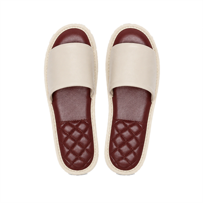 Ivory lambskin leather open-toe slippers with burgundy footbeds on a transparent background