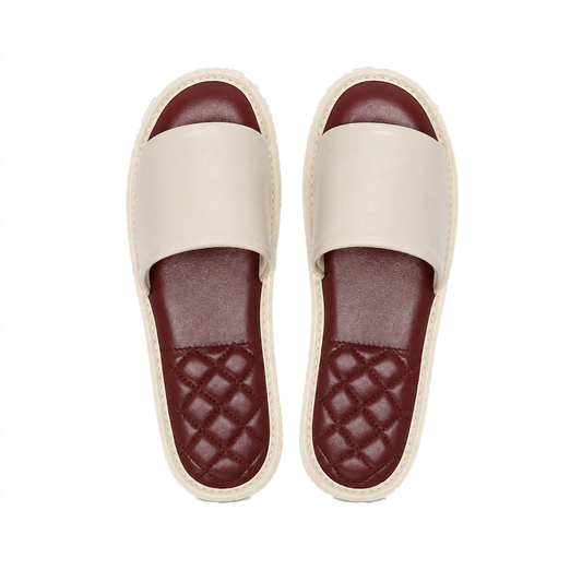 Ivory lambskin leather open-toe slippers with burgundy footbeds on a transparent background