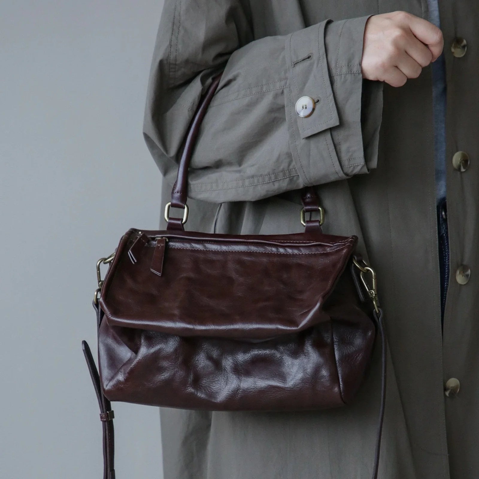 Ebony Brown vegetable-tanned leather shoulder bag worn at the front