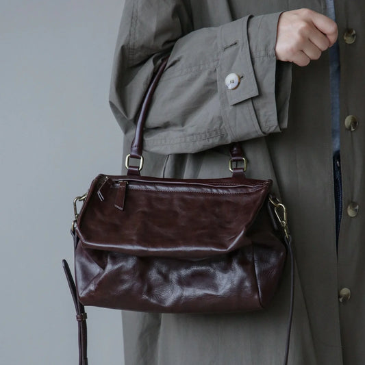 Ebony Brown vegetable-tanned leather shoulder bag worn at the front