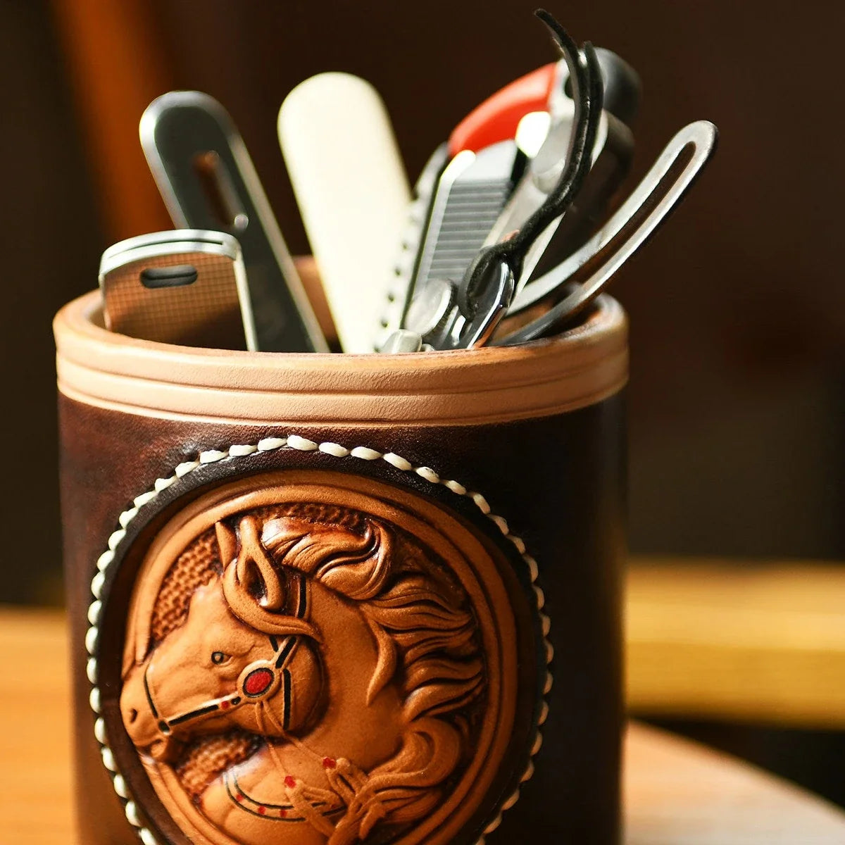 Hand-carved vegetable-tanned leather horse pen holder in use