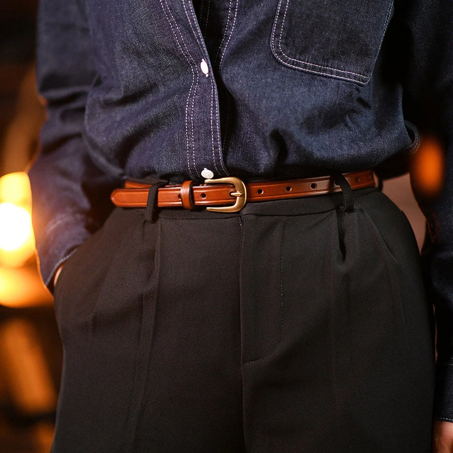 Brown top-grain leather slim belt styled with dark trousers