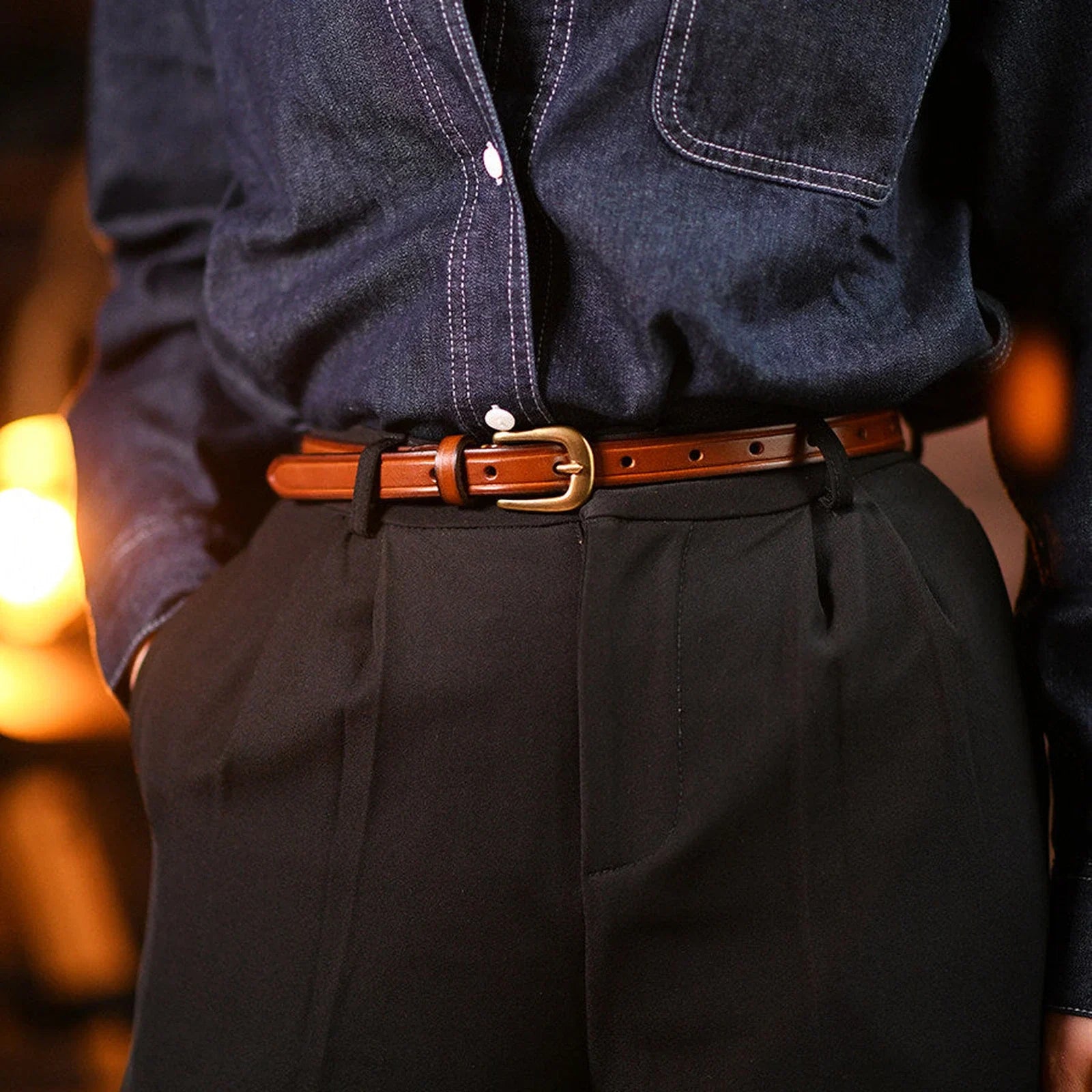 Brown top-grain leather slim belt styled with dark trousers