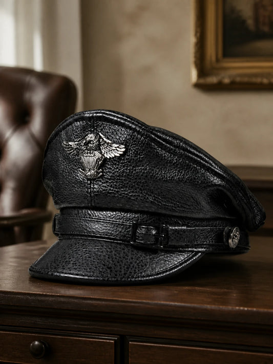 Men's genuine cowhide leather captain cap styled on a walnut console in a quiet study