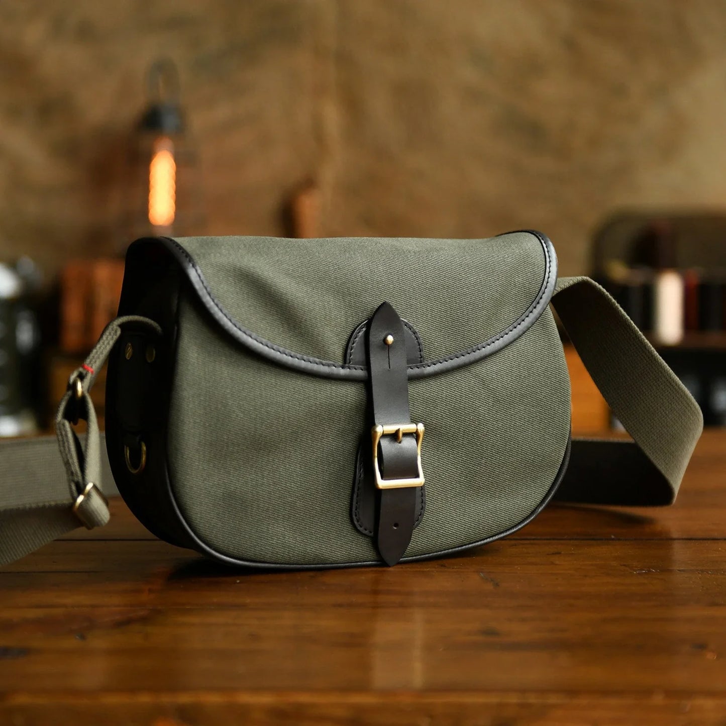 Olive green waxed canvas padded camera crossbody bag front view