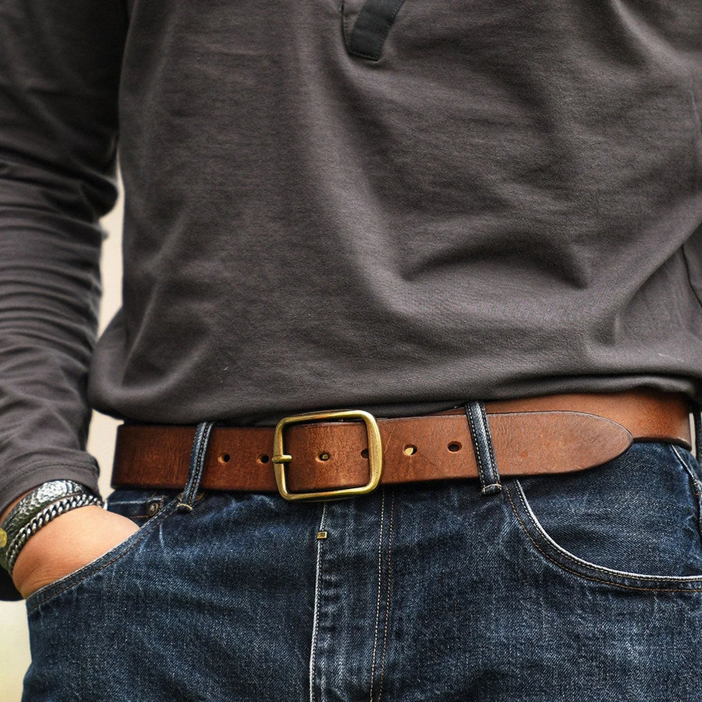 Men's rustic brown top-grain cowhide belt styled with denim