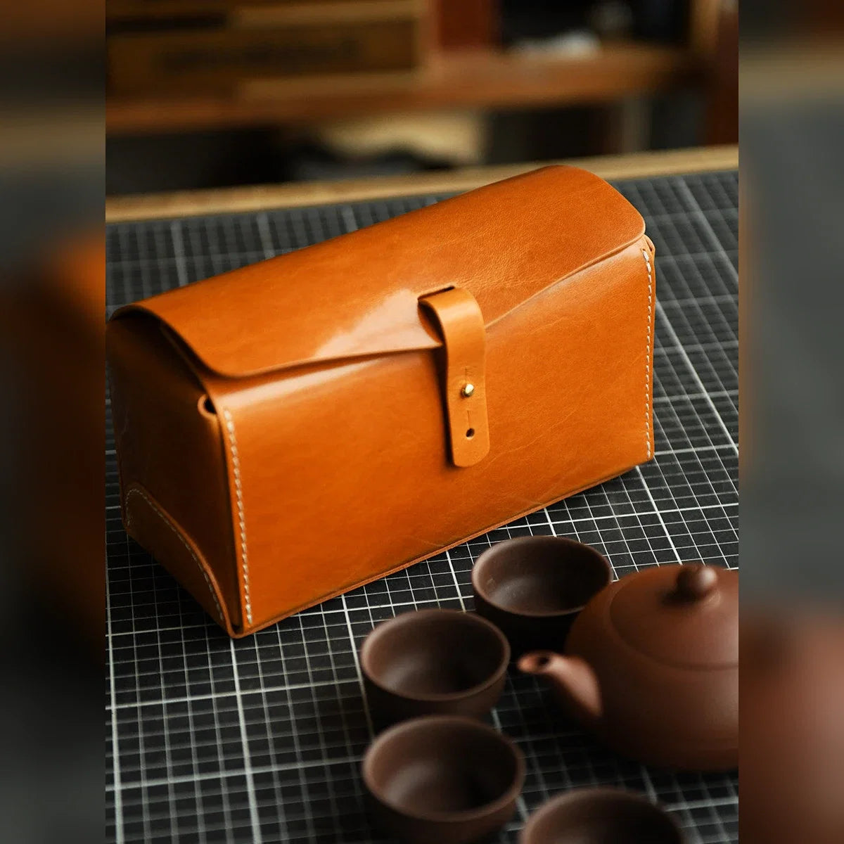 Vegetable-tanned cowhide travel case arranged with a compact tea set
