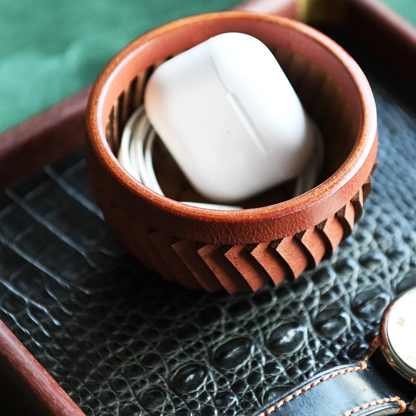 Top-grain cowhide storage bowl styled with everyday essentials