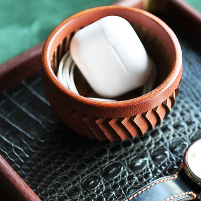 Top-grain cowhide storage bowl styled with everyday essentials
