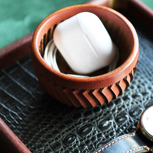 Top-grain cowhide storage bowl styled with everyday essentials