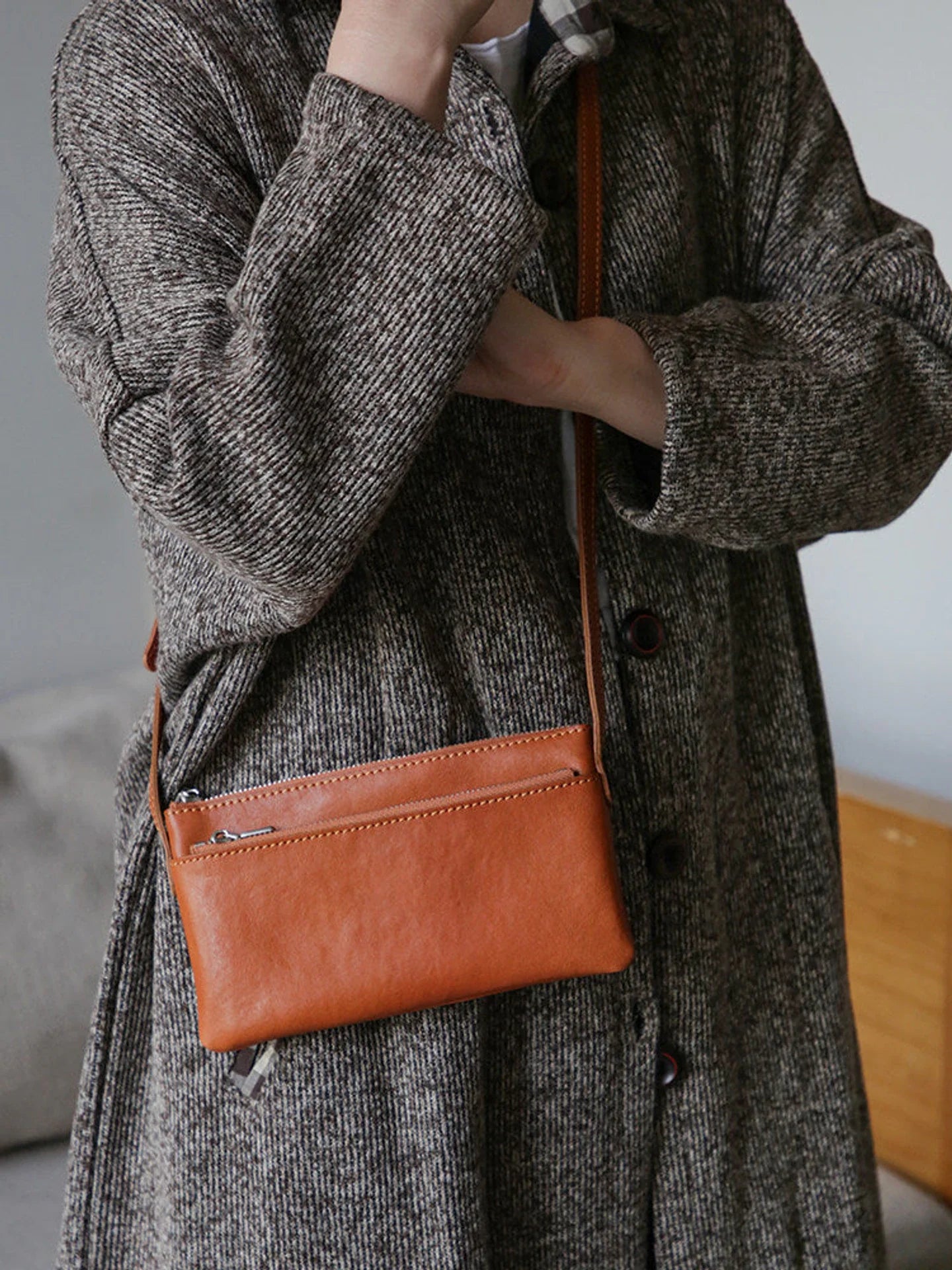 Cognac brown top-grain leather slim phone bag worn crossbody
