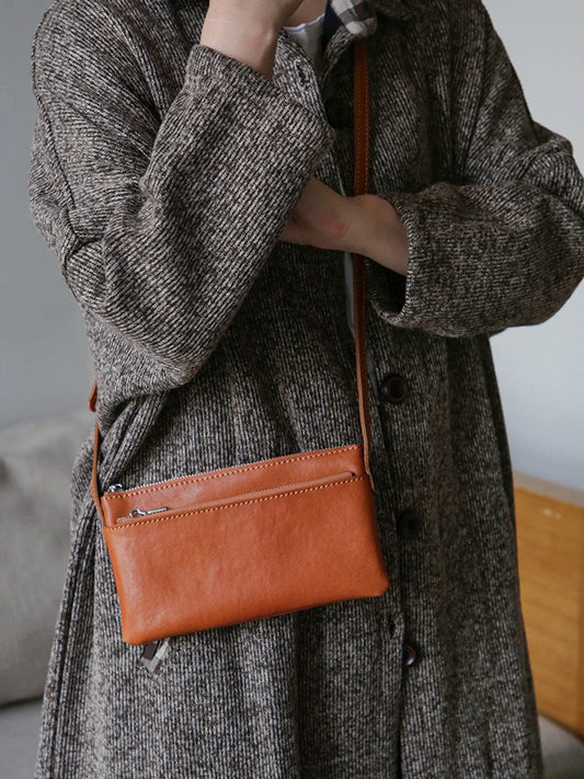 Cognac brown top-grain leather slim phone bag worn crossbody
