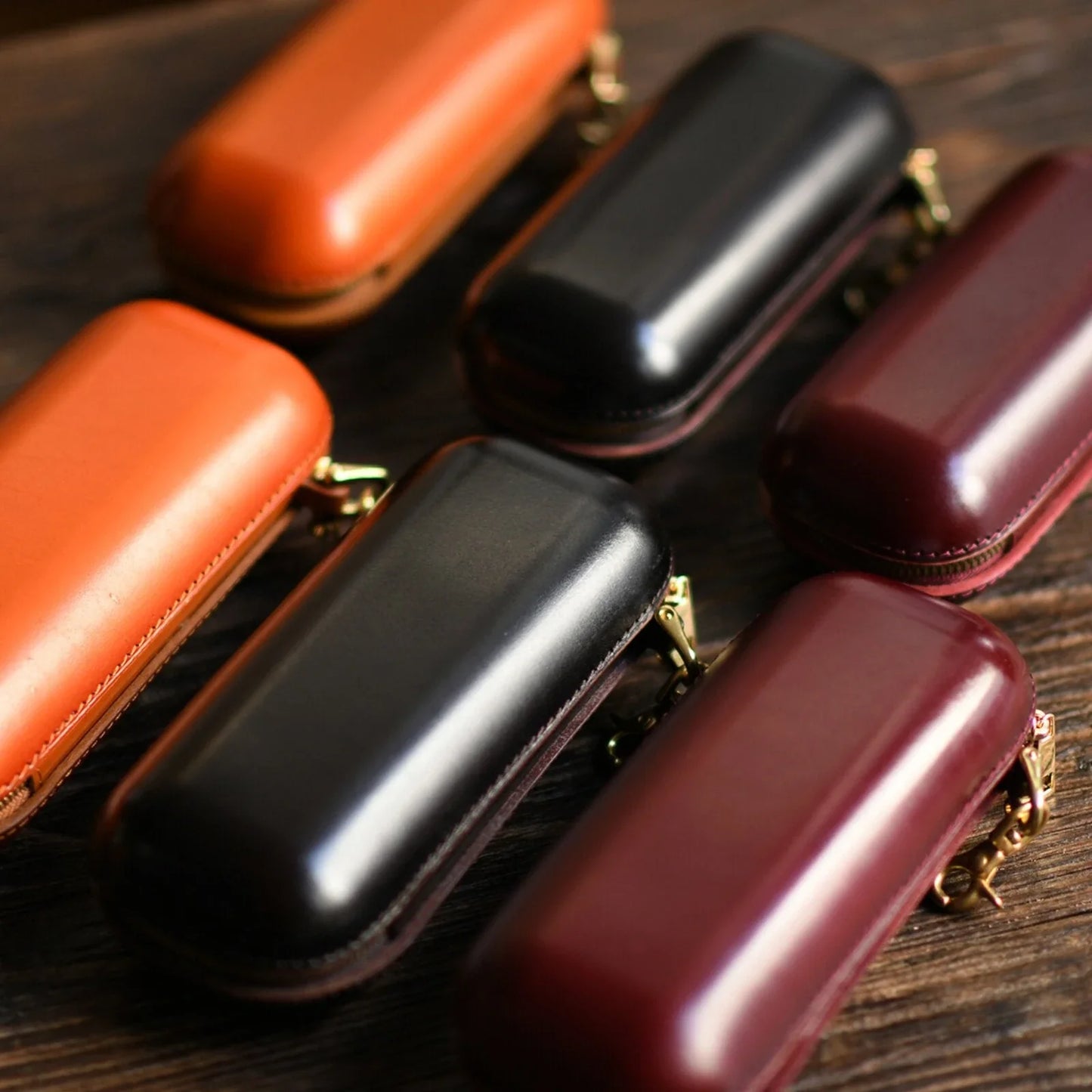Vegetable-tanned leather eyeglass cases in tan, burgundy, and dark brown