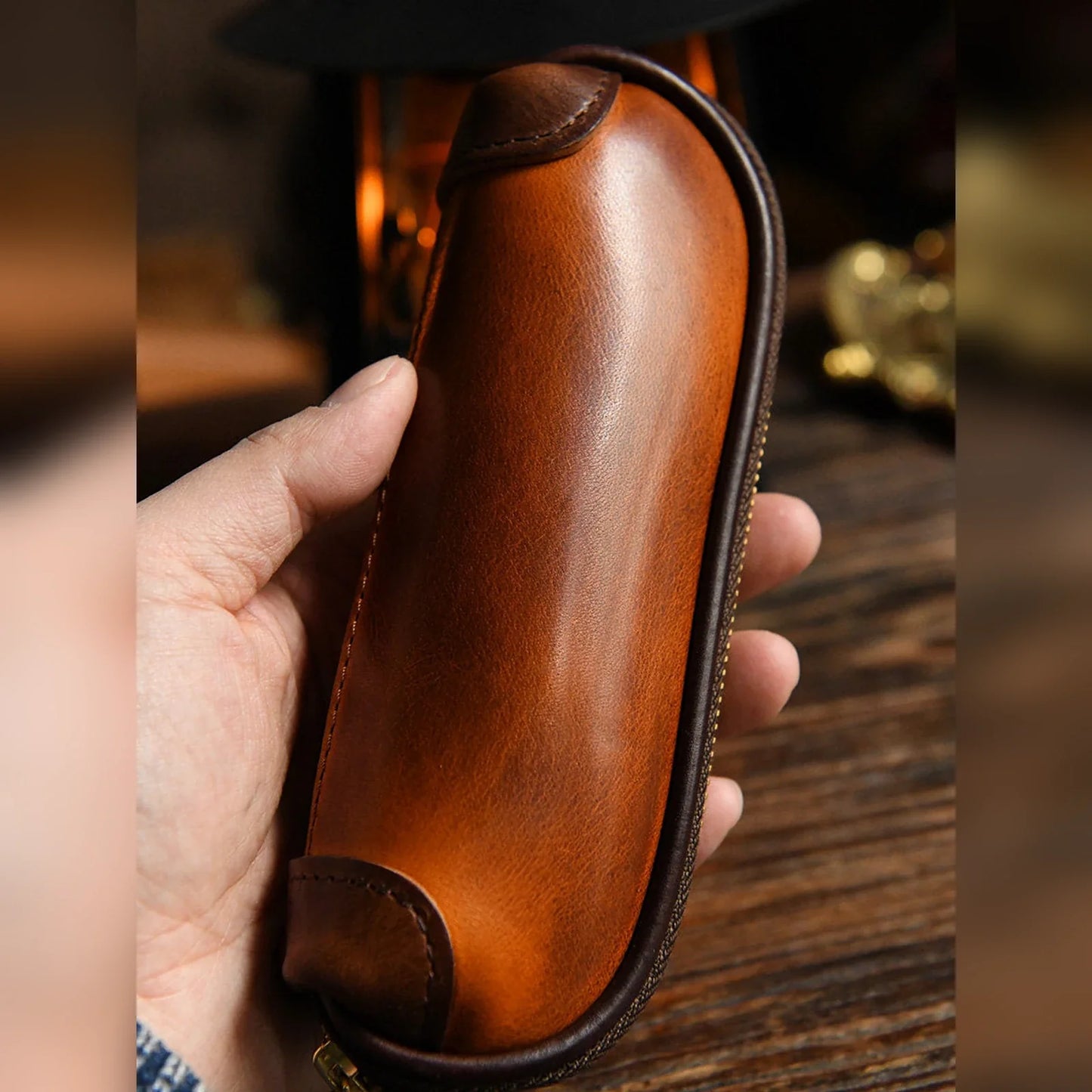 Handcrafted vegetable-tanned leather pencil case held in hand