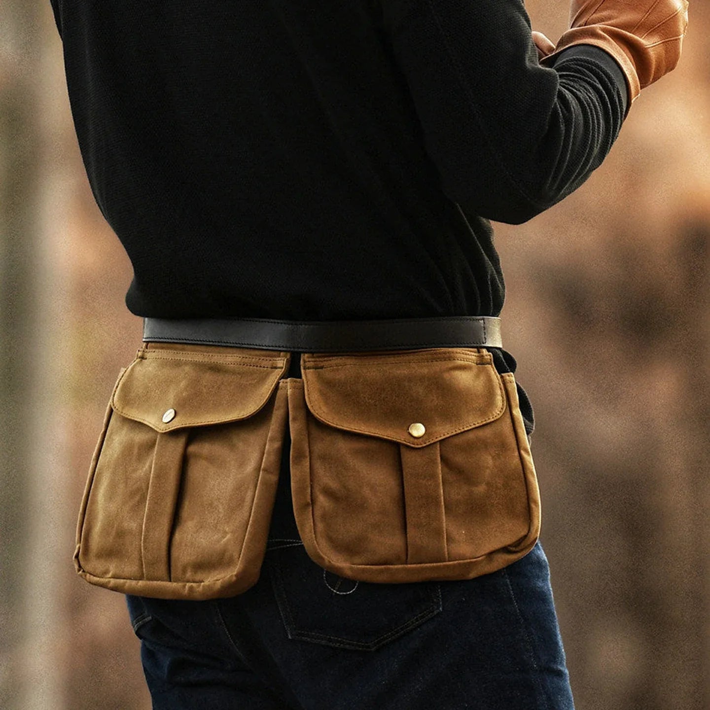 Waxed canvas multi-pocket waist bag worn securely around the hips