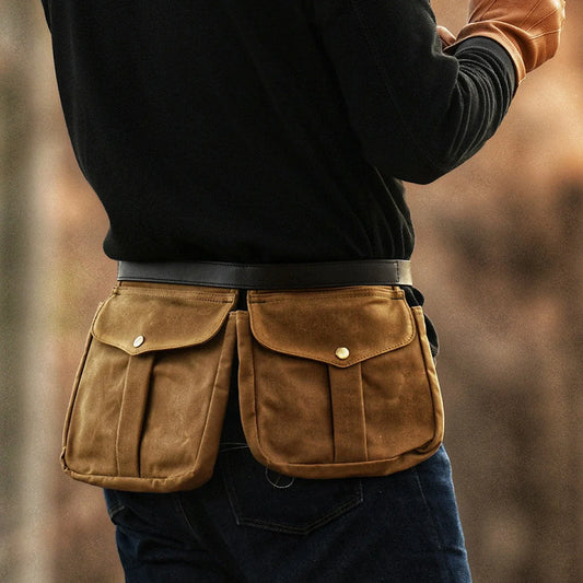 Waxed canvas multi-pocket waist bag worn securely around the hips
