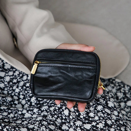 Women's black top-grain cowhide coin wallet with horizontal zip design
