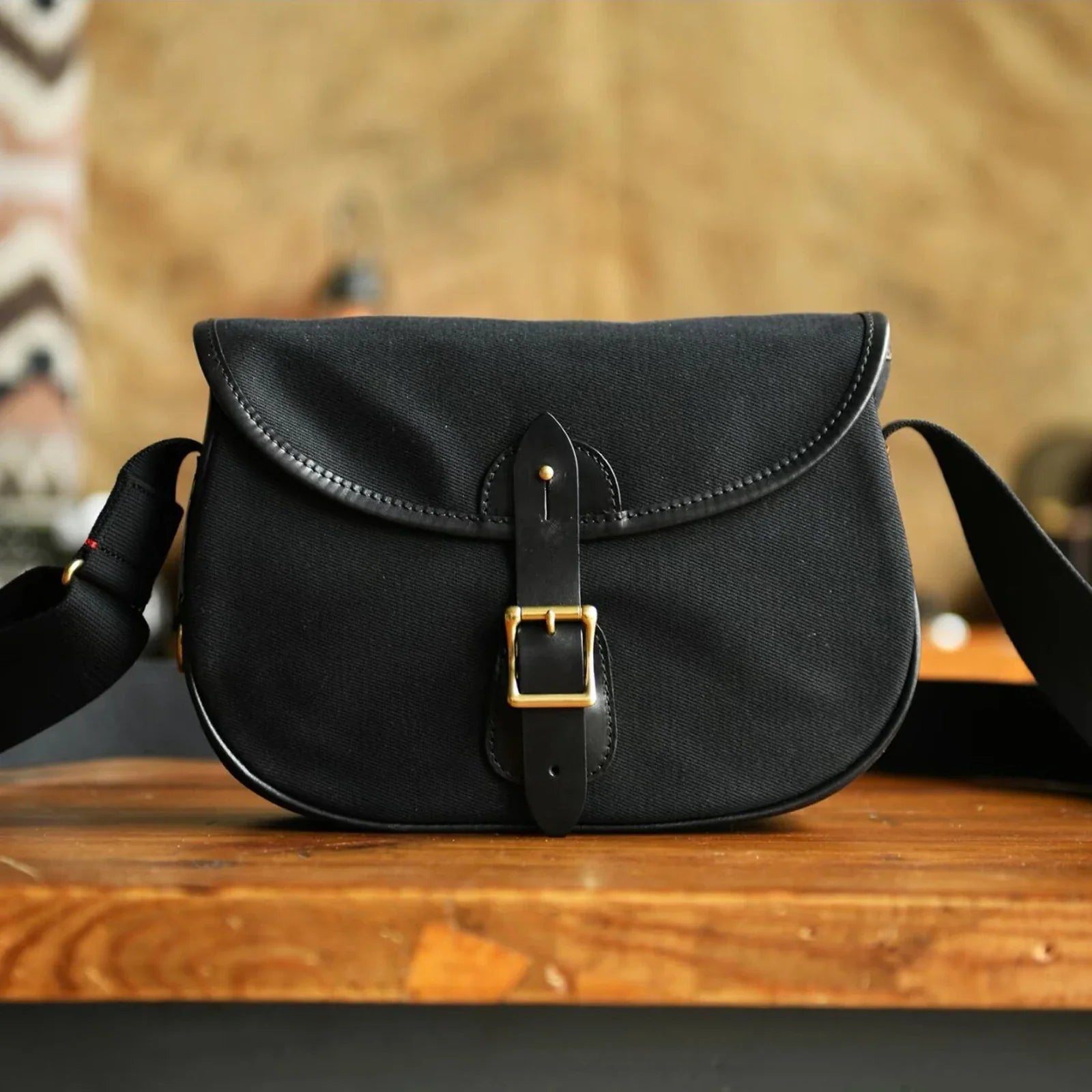 Black waxed canvas padded camera crossbody bag front view