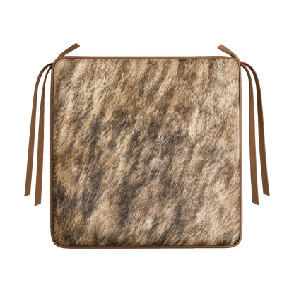 Brown brindle genuine cowhide square chair pad with leather border and tie straps on transparent background
