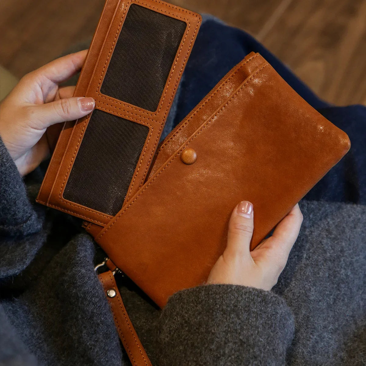 Brown leather long wallet opened to show card and photo compartments